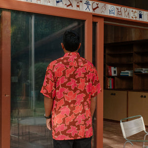 man wearing aloha shirt with vibrant pink pua pattern