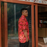 man wearing aloha shirt with vibrant pink pua pattern