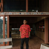man wearing aloha shirt with vibrant pink pua pattern