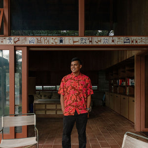man wearing aloha shirt with vibrant pink pua pattern
