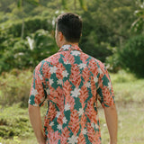 man wearing an aloha button up shirt with red ginger and tiare print