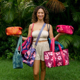 woman holding expandable puakenikeni printed neoprene pouch with detachable mini pouches