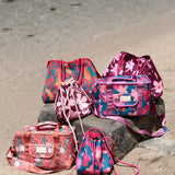 brown neoprene drawstring crossbody purse with pink hibiscus pattern