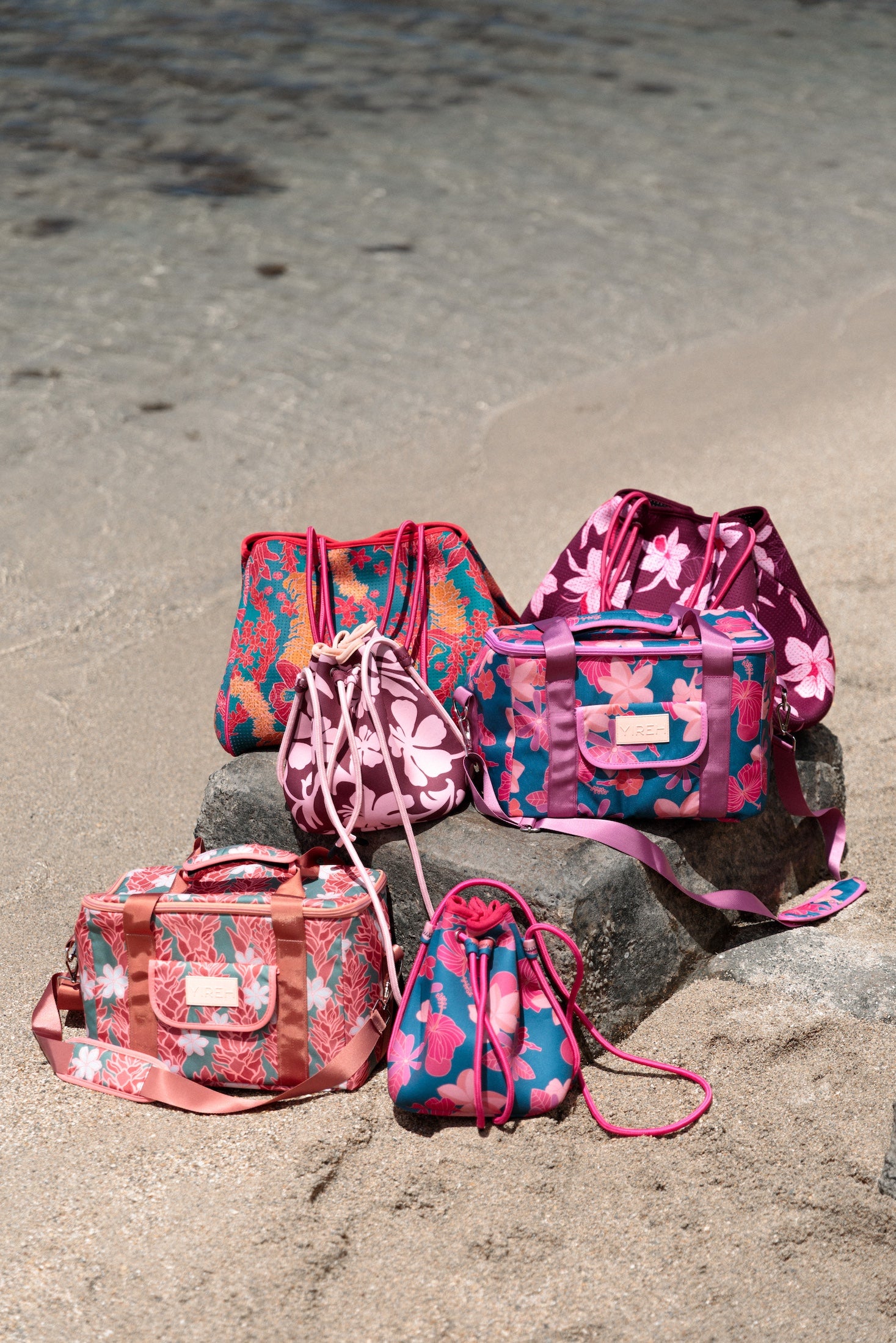 brown neoprene drawstring crossbody purse with pink hibiscus pattern