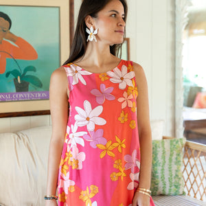 woman with brown hair wearing pink high neck scoop back mini dress with retro flower print