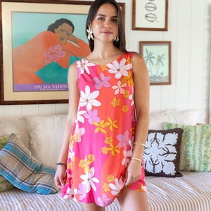  woman with brown hair wearing pink high neck scoop back mini dress with retro flower print