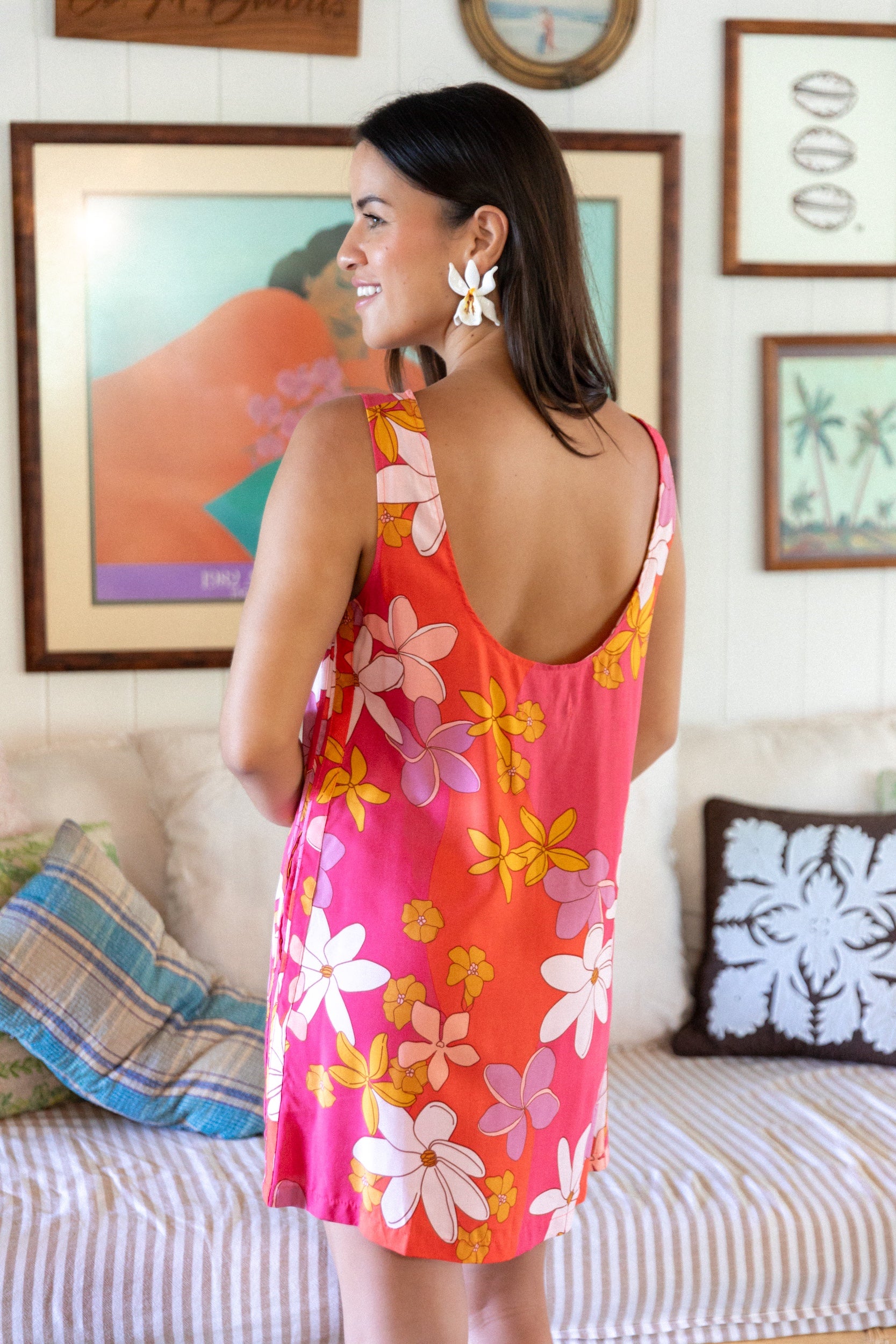 woman with brown hair wearing pink high neck scoop back mini dress with retro flower print