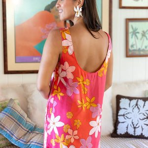 woman with brown hair wearing pink high neck scoop back mini dress with retro flower print