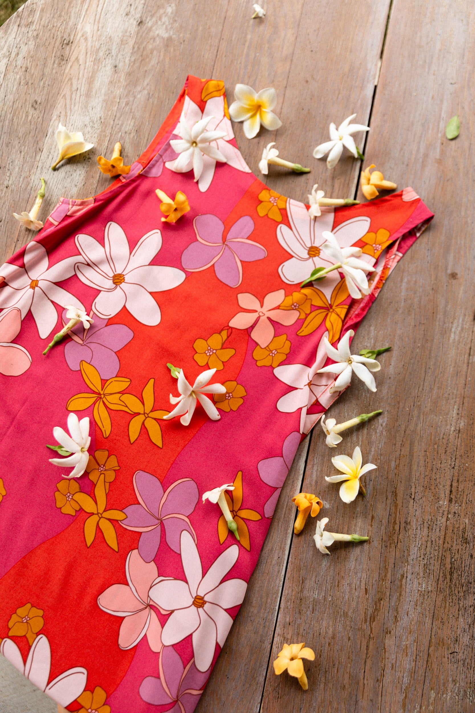 woman with brown hair wearing a pink high neck scoop back mini dress with retro flower print