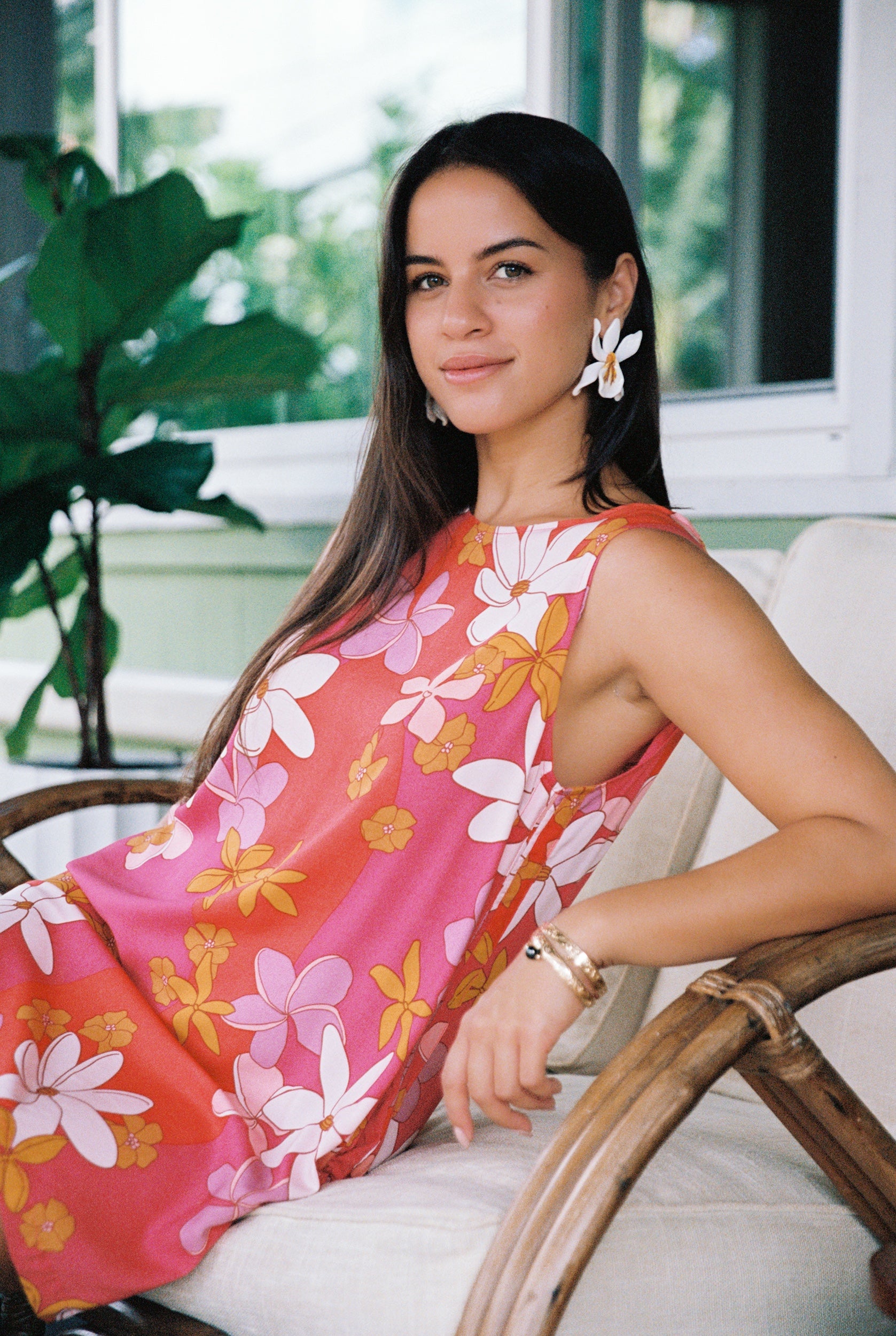 woman with brown hair wearing pink high neck scoop back mini dress with retro flower print