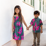 little girl with brown hair wearing a smocked spaghetti strap dress with fern and ginger print