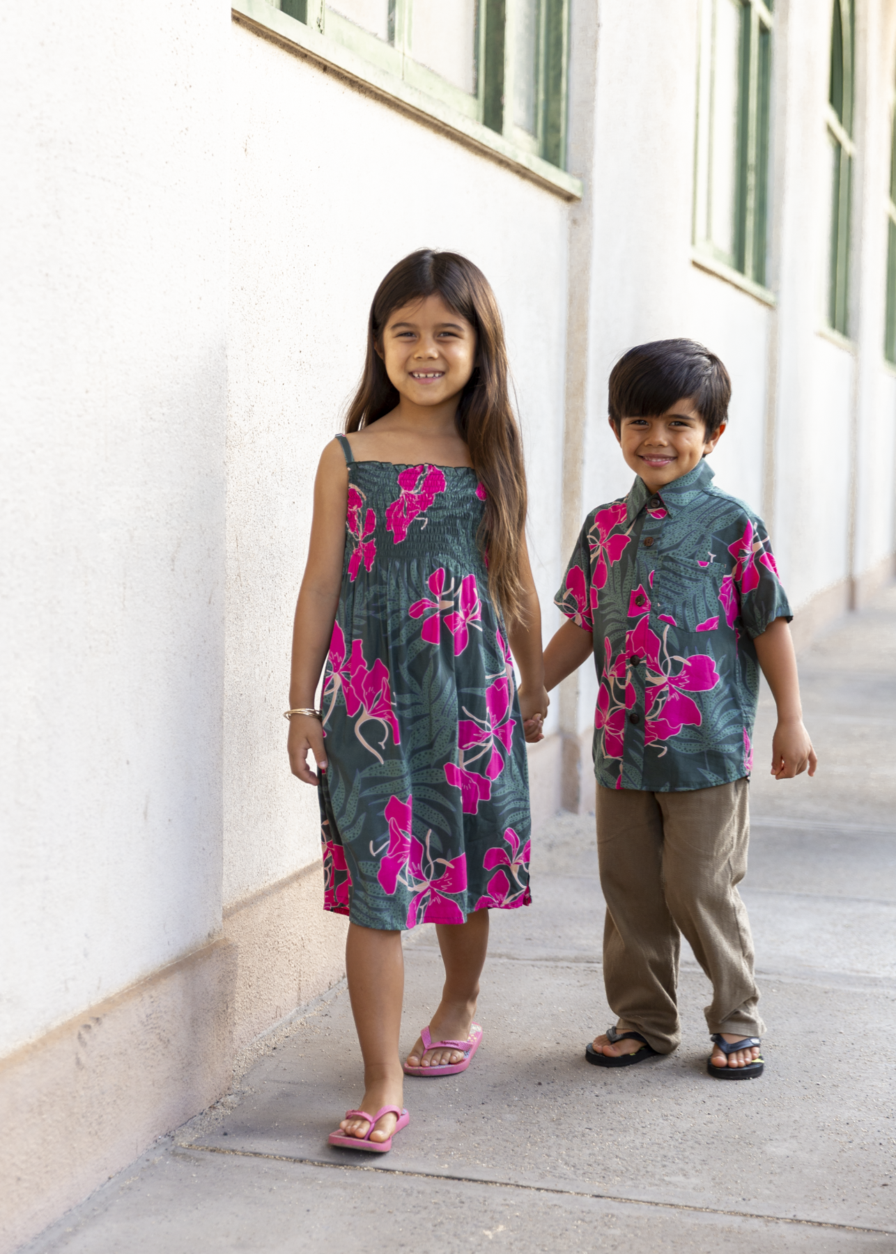 little boy with brown hair wearing mini aloha button up top with fern and ginger print