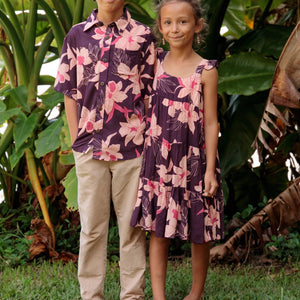 little boy wearing a dark purple aloha button up shirt with orchid print