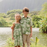 little boy wearing green aloha shirt with native Hawaiian plants
