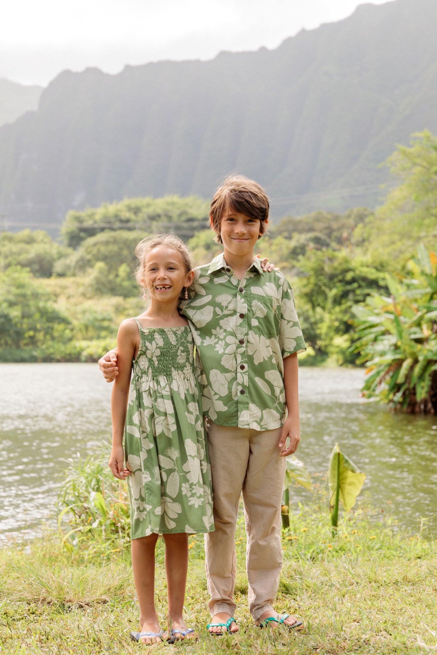 little boy wearing green aloha shirt with native Hawaiian plants