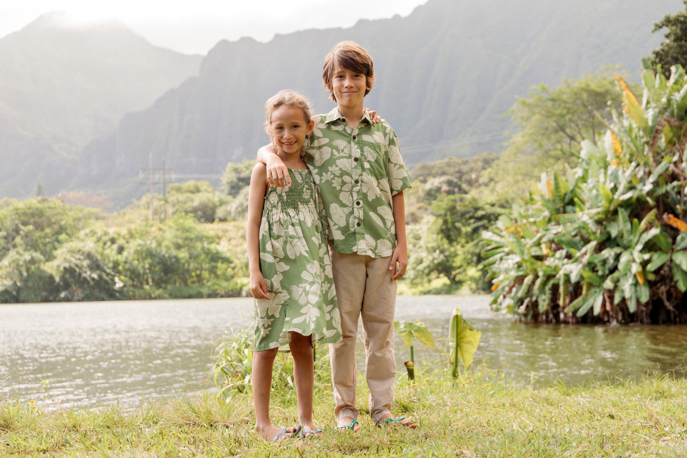 little girl wearing green smocked dress with native Hawaiian plants