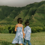 little girl wearing blue paniolo paisley printed dress with tie straps