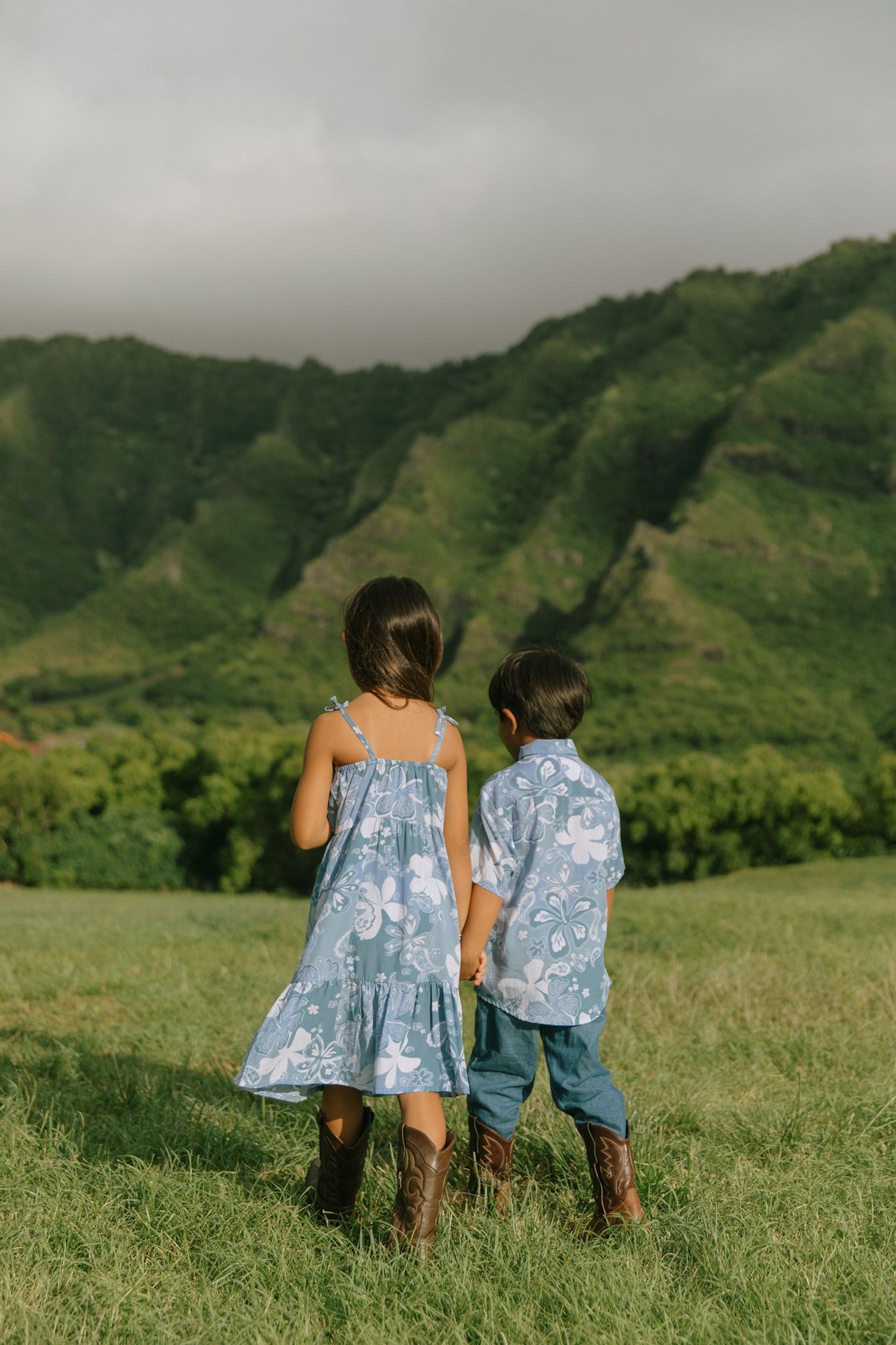 little girl wearing blue paniolo paisley printed dress with tie straps