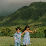 little girl wearing blue paniolo paisley printed dress with tie straps