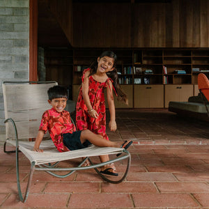 little girl wearing jumpsuit with retro pink pua pattern