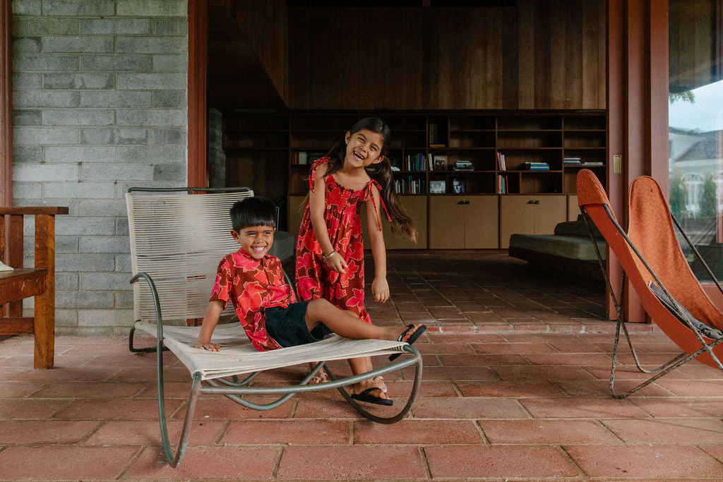 little girl wearing jumpsuit with retro pink pua pattern