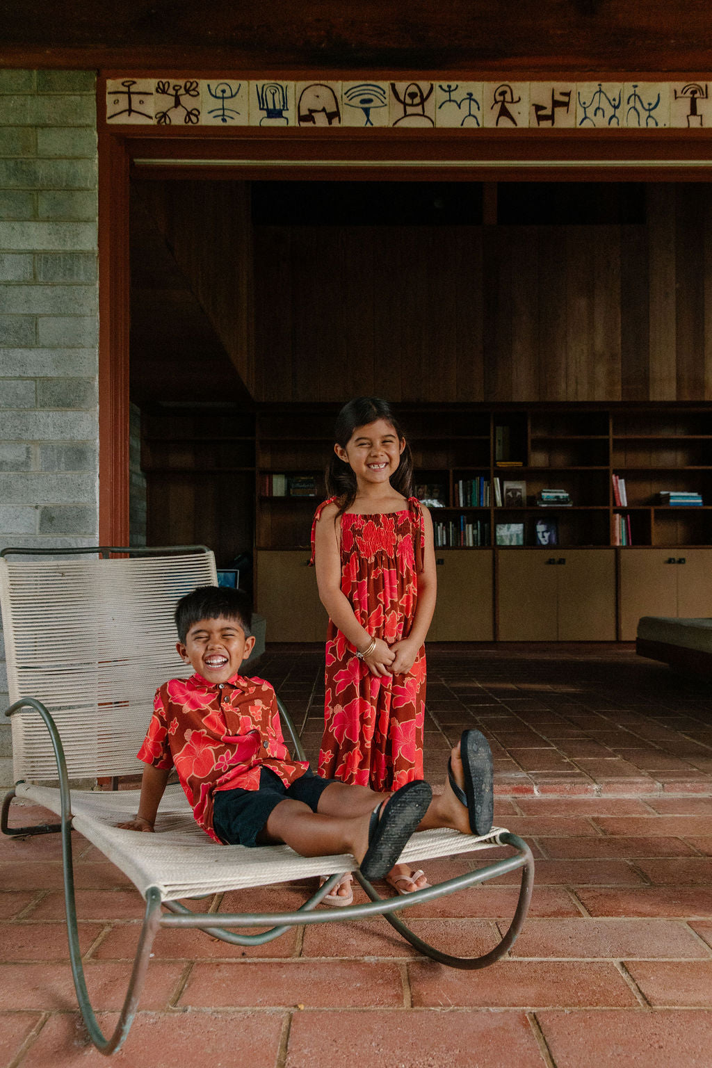little girl wearing jumpsuit with retro pink pua pattern