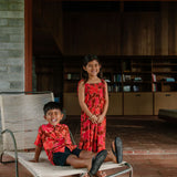 little girl wearing jumpsuit with retro pink pua pattern