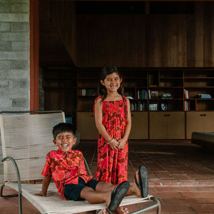 little girl wearing jumpsuit with retro pink pua pattern