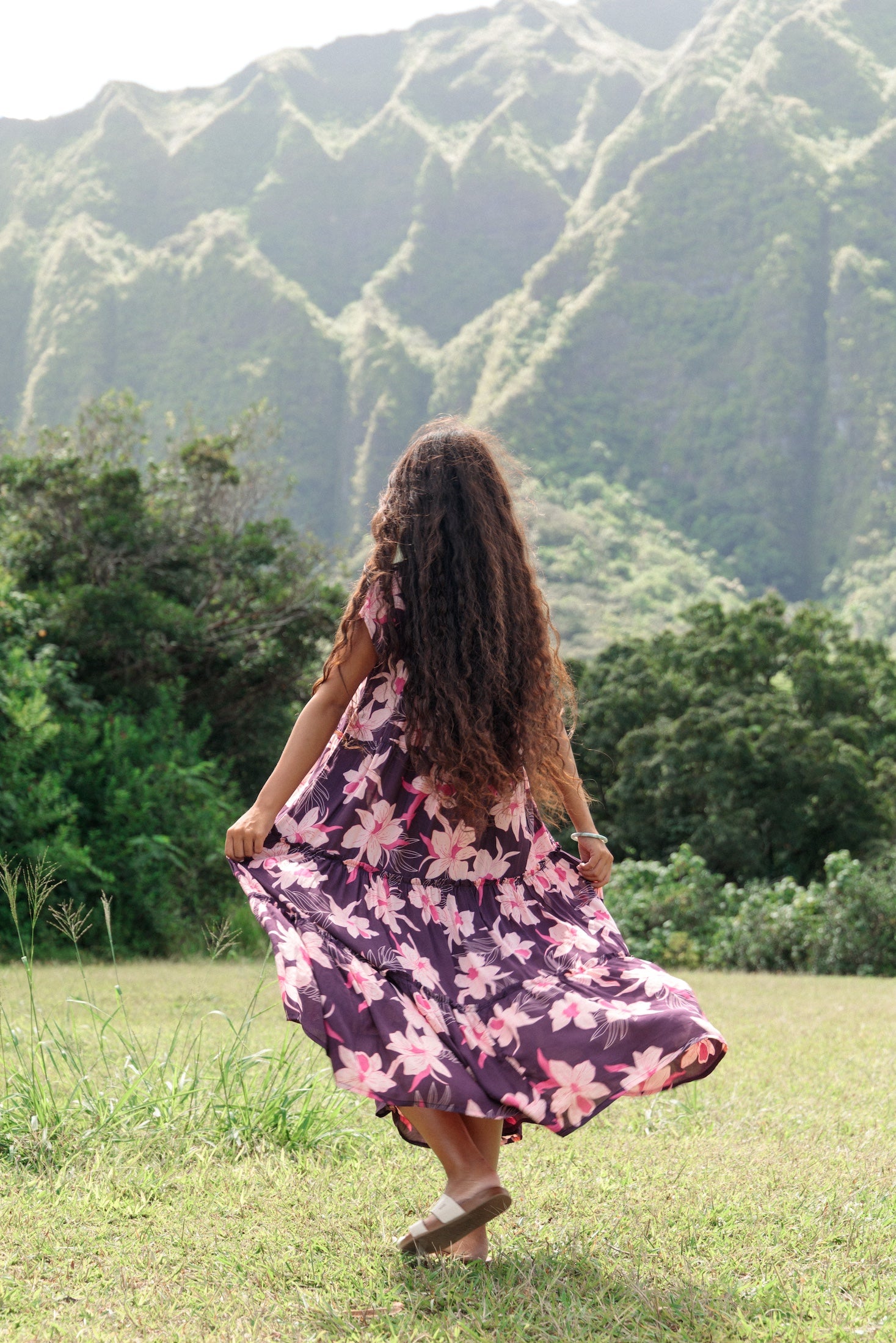 woman wearing dark purple maxi dress with orchid print