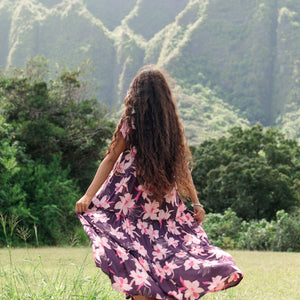 woman wearing dark purple maxi dress with orchid print