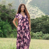woman wearing dark purple maxi dress with orchid print