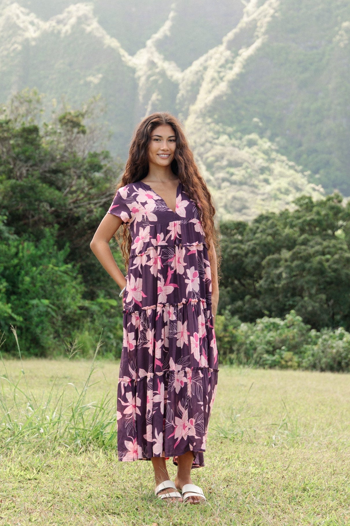 woman wearing dark purple maxi dress with orchid print