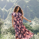 woman wearing dark purple maxi dress with orchid print