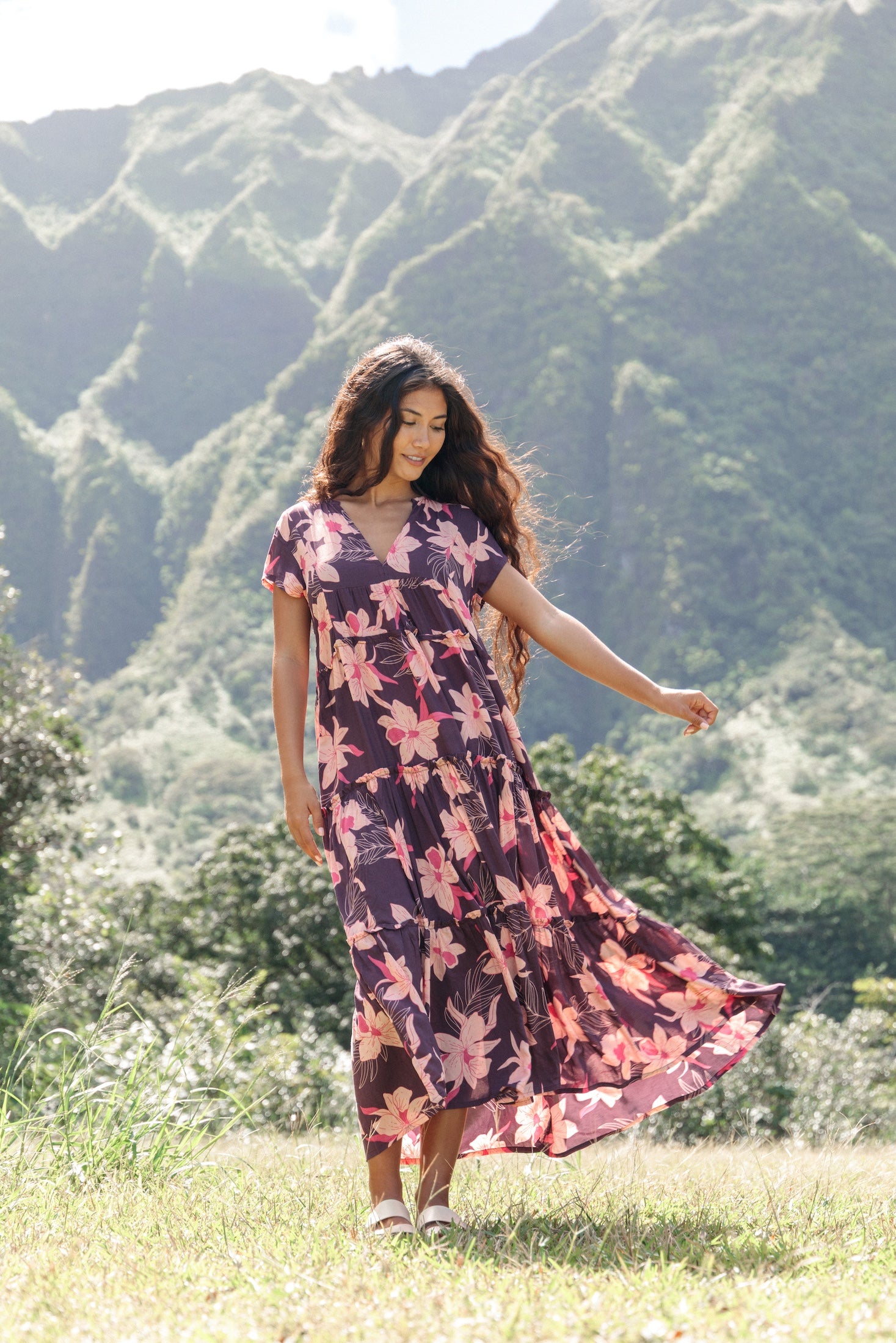 woman wearing dark purple maxi dress with orchid print