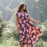 woman wearing dark purple maxi dress with orchid print