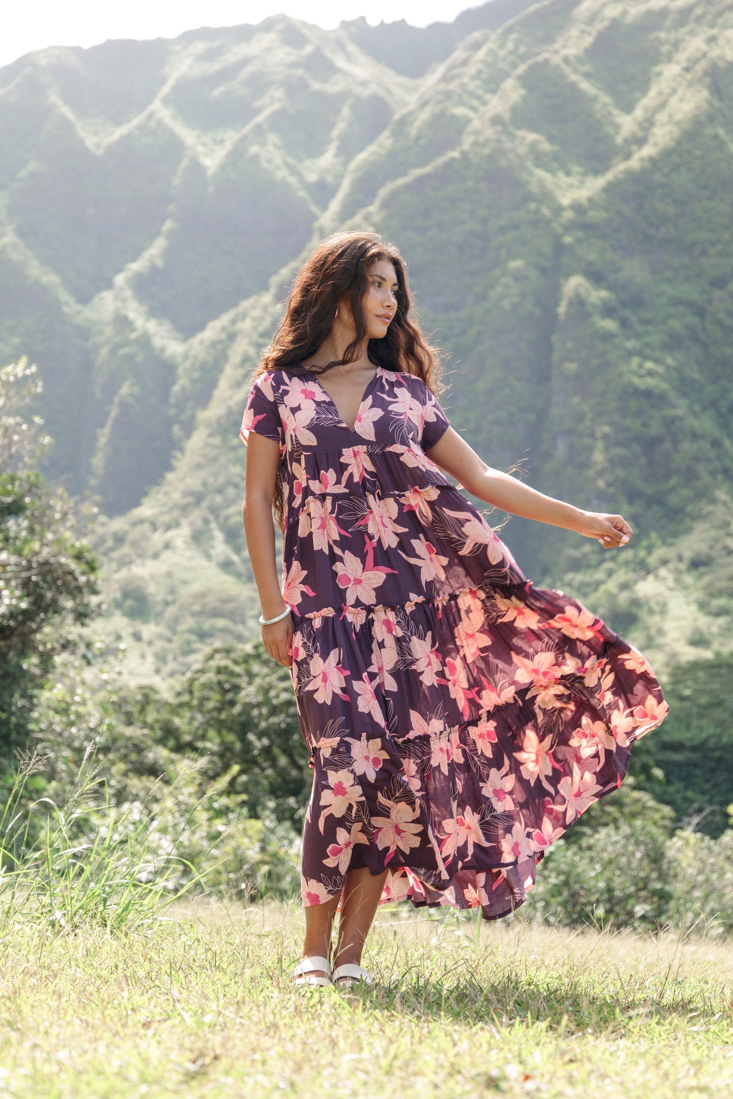 woman wearing dark purple maxi dress with orchid print
