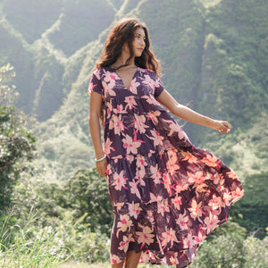 woman wearing dark purple maxi dress with orchid print