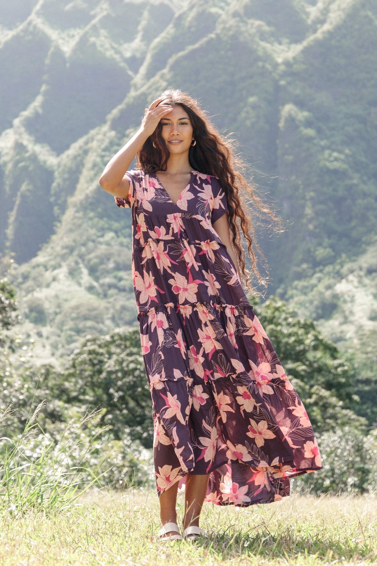 woman wearing dark purple maxi dress with orchid print
