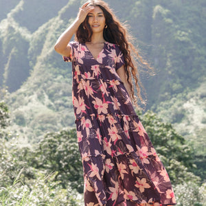 woman wearing dark purple maxi dress with orchid print