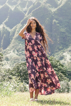 woman wearing dark purple maxi dress with orchid print