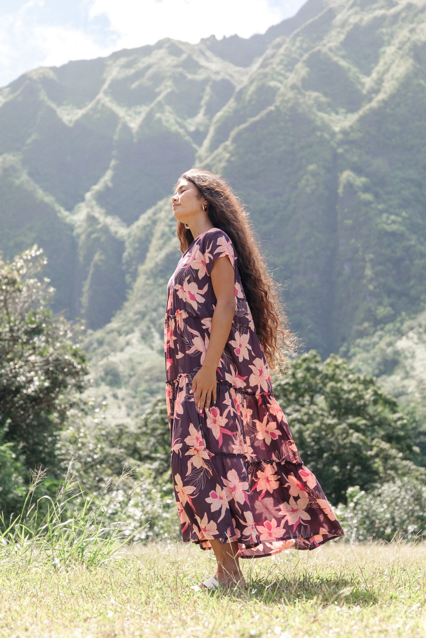 woman wearing dark purple maxi dress with orchid print