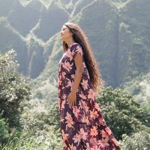 woman wearing dark purple maxi dress with orchid print