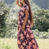 woman wearing dark purple maxi dress with orchid print