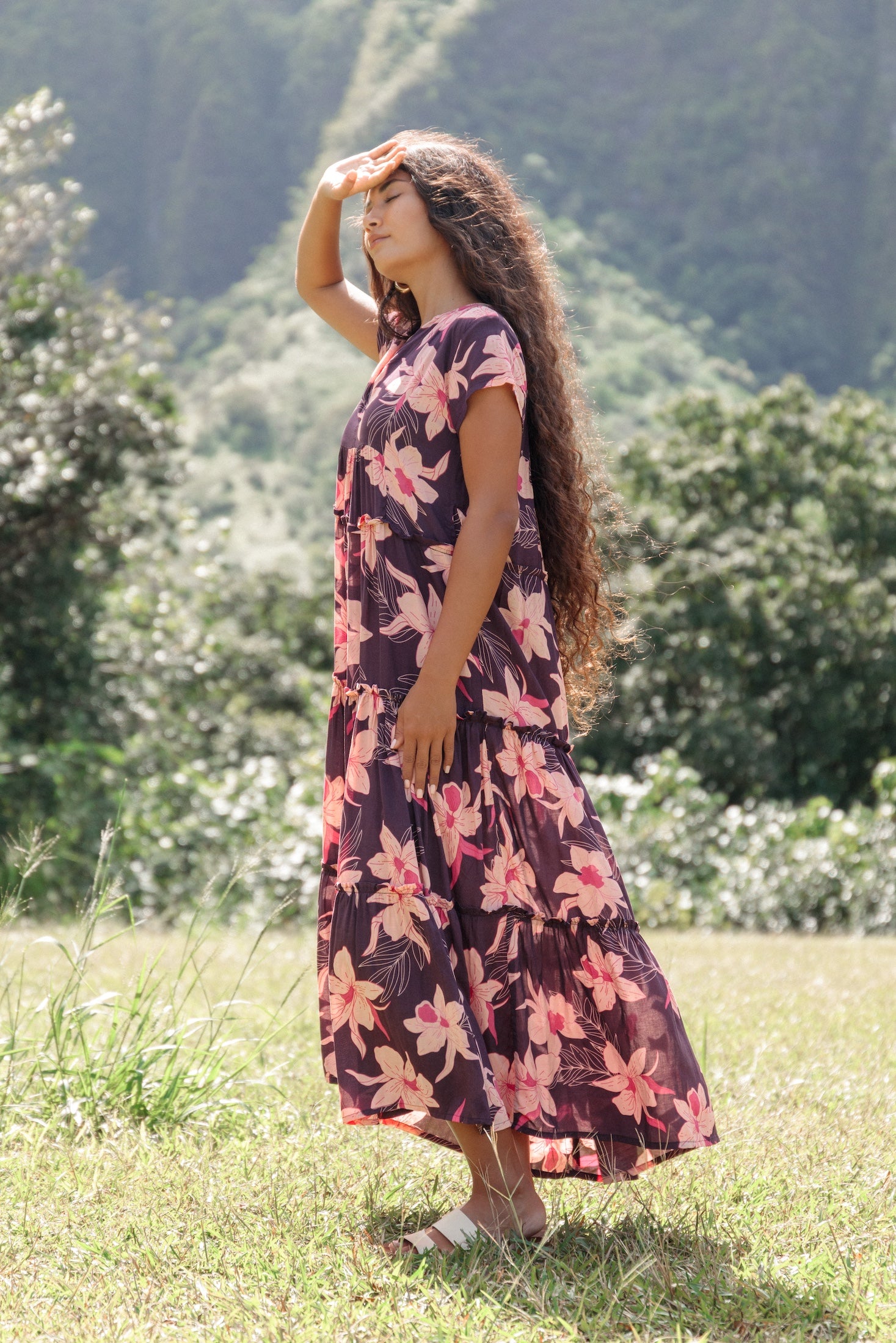woman wearing dark purple maxi dress with orchid print