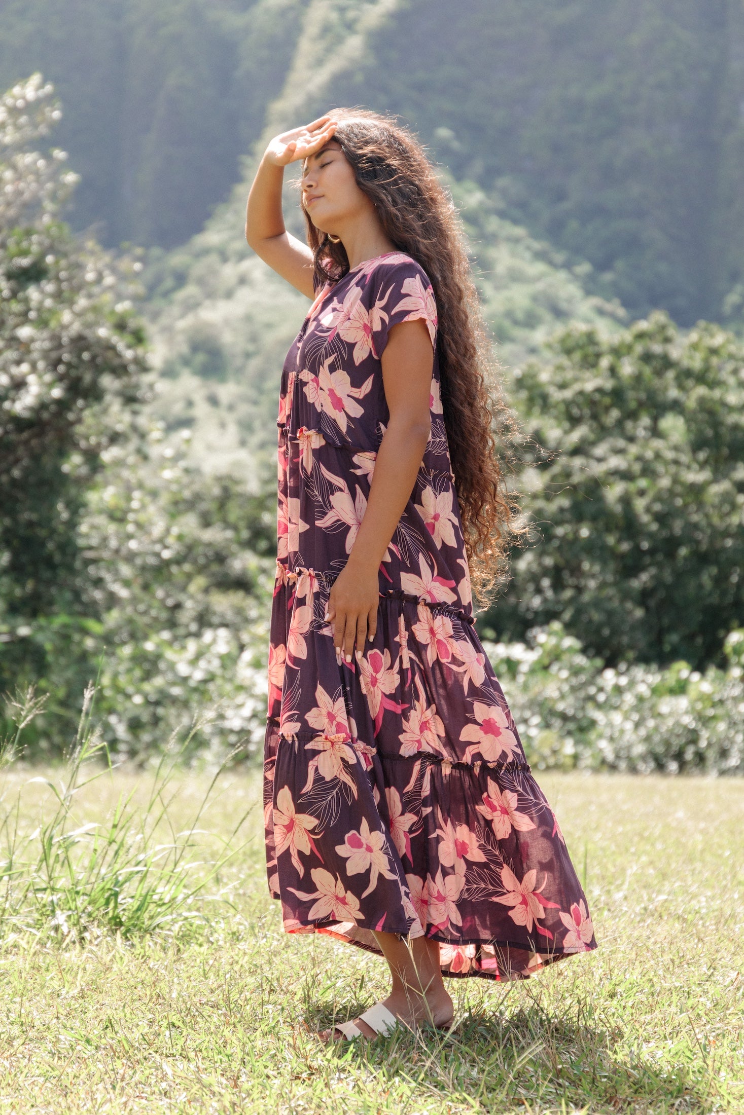 woman wearing dark purple maxi dress with orchid print