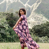 woman wearing dark purple maxi dress with orchid print