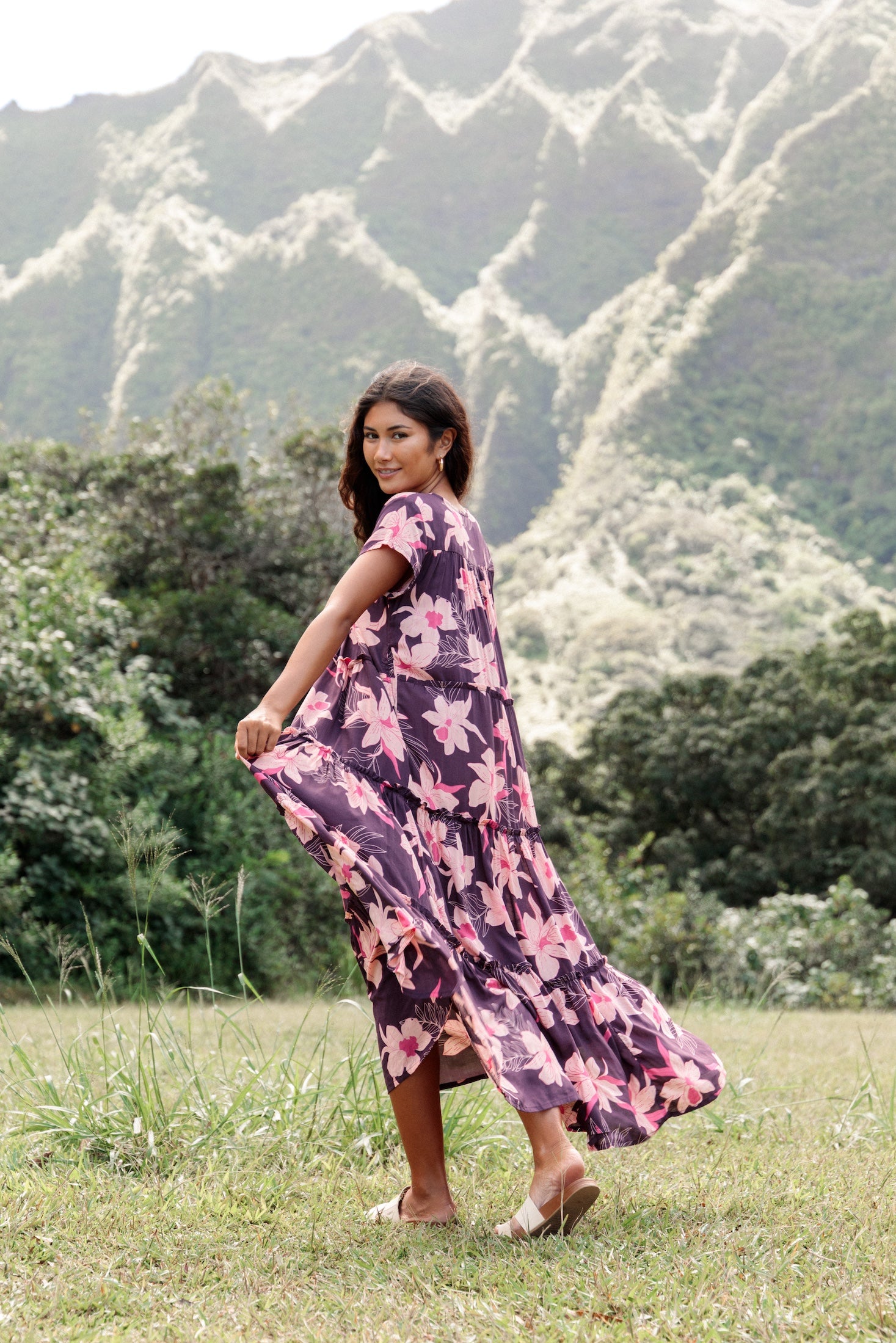 woman wearing dark purple maxi dress with orchid print