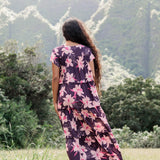 woman wearing dark purple maxi dress with orchid print