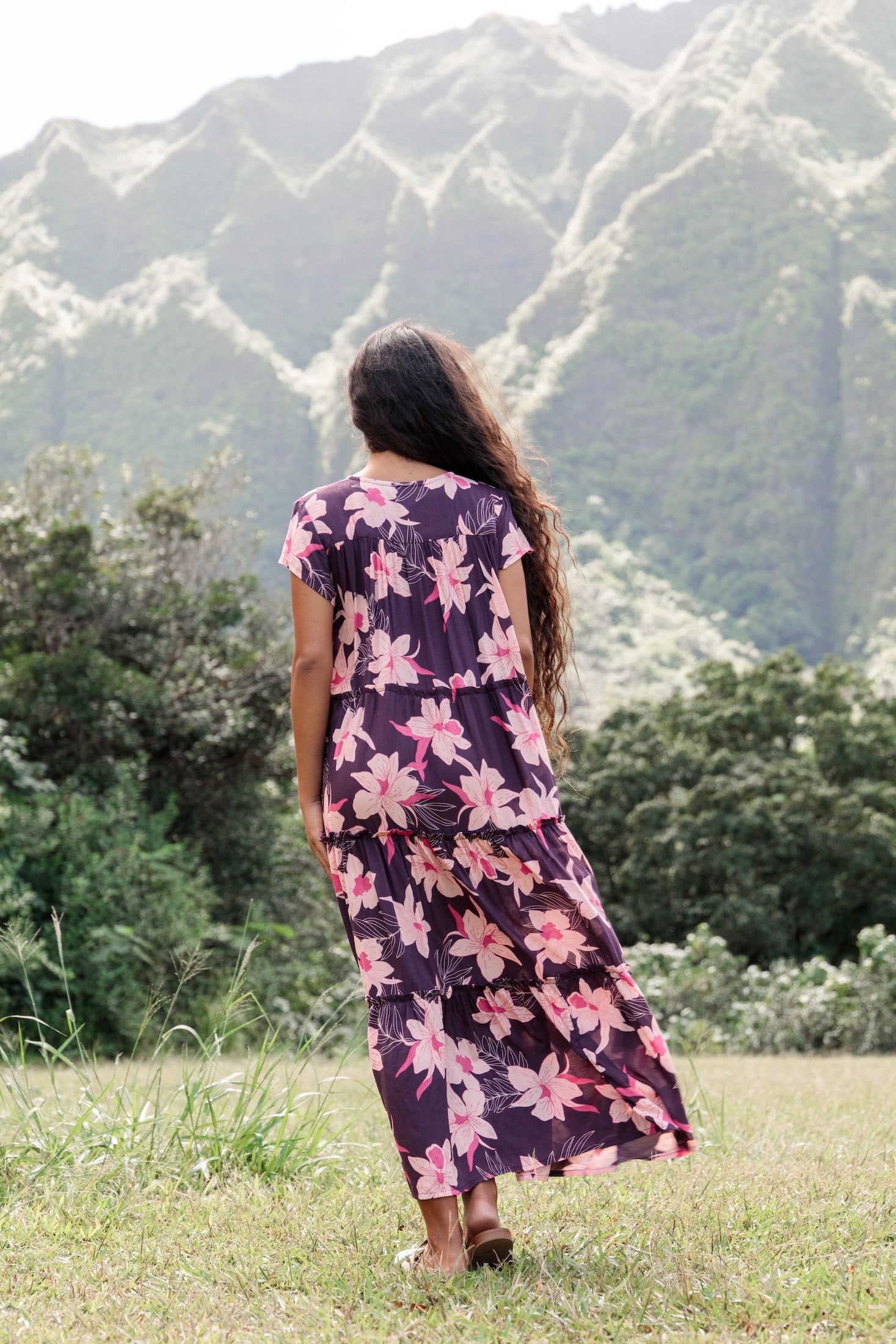 woman wearing dark purple maxi dress with orchid print