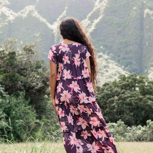 woman wearing dark purple maxi dress with orchid print